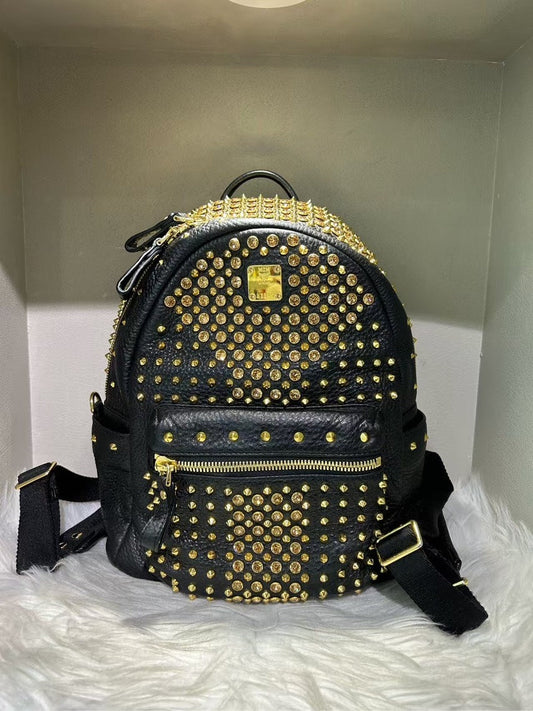 Pre-loved MCM Stark Black Backpack with Gold Studs